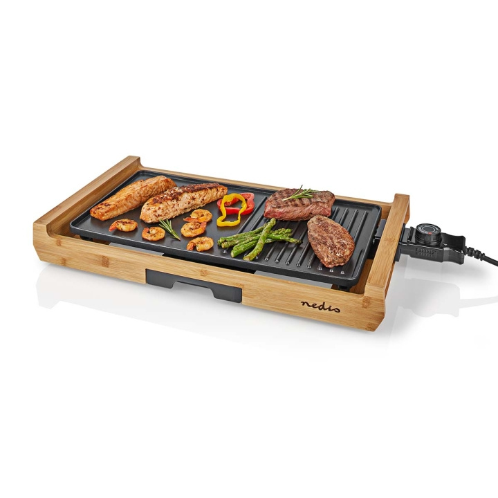 Nedis Teppanyaki Table Grill | Baking surface ( l x w ): 43 x 23 cm | Number of persons: 6 Persons | Non stick coating | 4 Heat Settings in the group HOME, HOUSEHOLD & GARDEN / Household appliances / Cooktops and Hot plates at TP E-commerce Nordic AB (C08138)